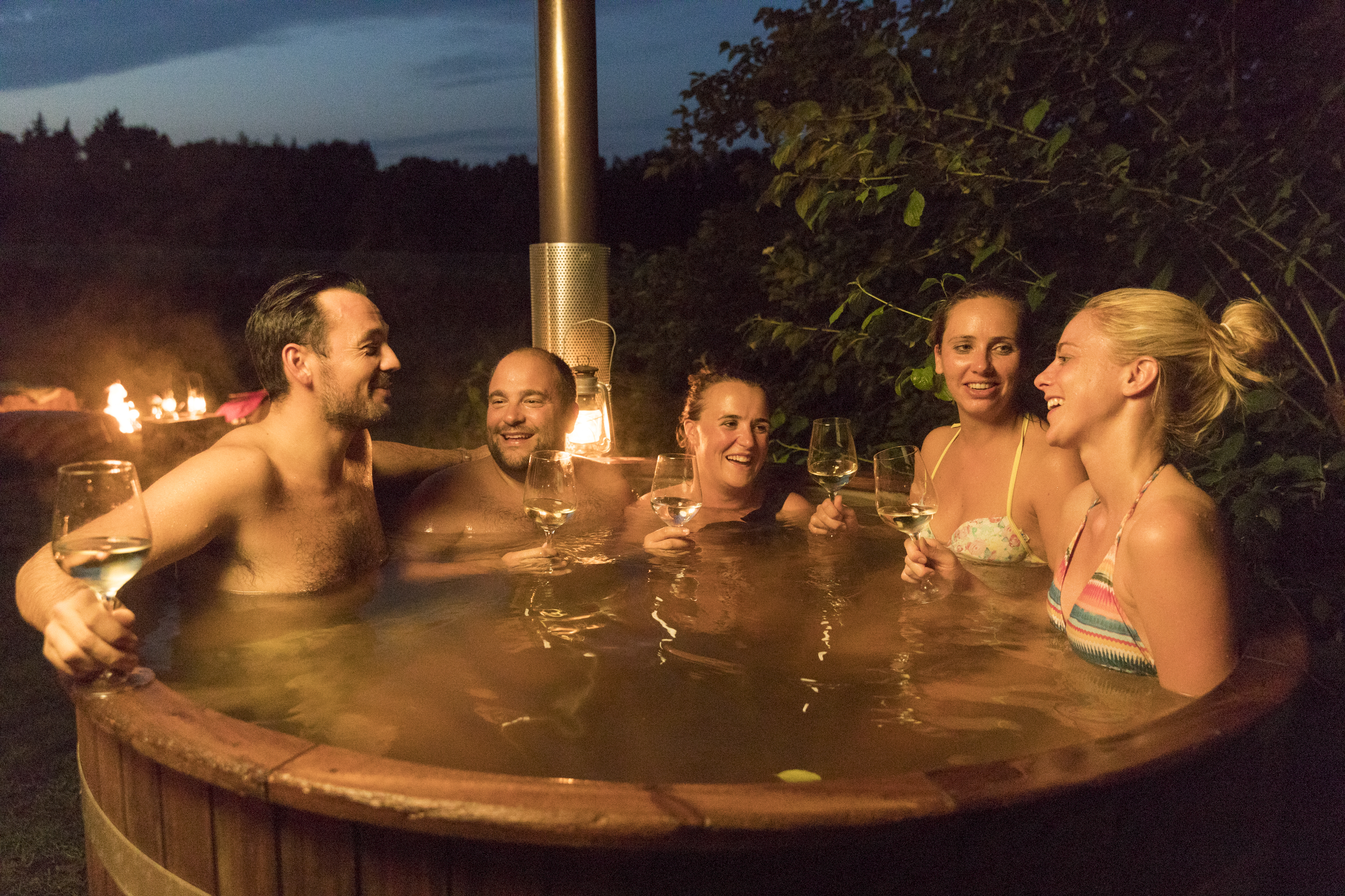Adults in hot tub during evening